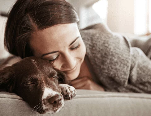 Woman Cuddles With Her Dog