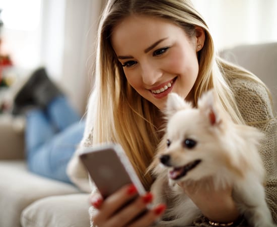 Woman and dog downloading our app